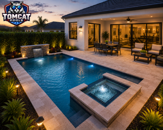 Freeform pool with round raised spa, in-water loungers, and fire pit by Tomcat Pools