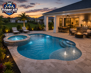 Rectangular pool with fire pit lounge and paver deck by Tomcat Pools